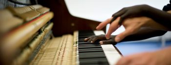 Hands playing piano in therapy session